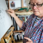 Lyn Carruthers making a self portrait in her studio in 2019
